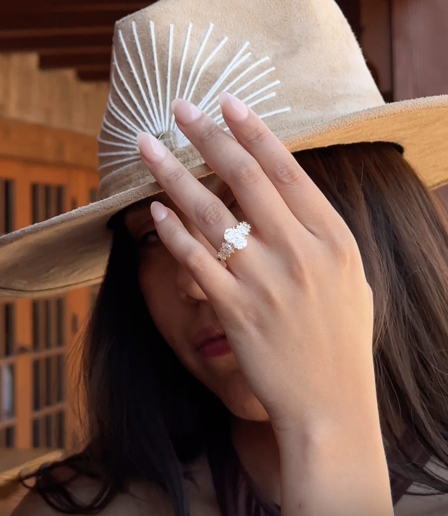 Sarah O. engagement ring styled with a hand-stitched suede hat