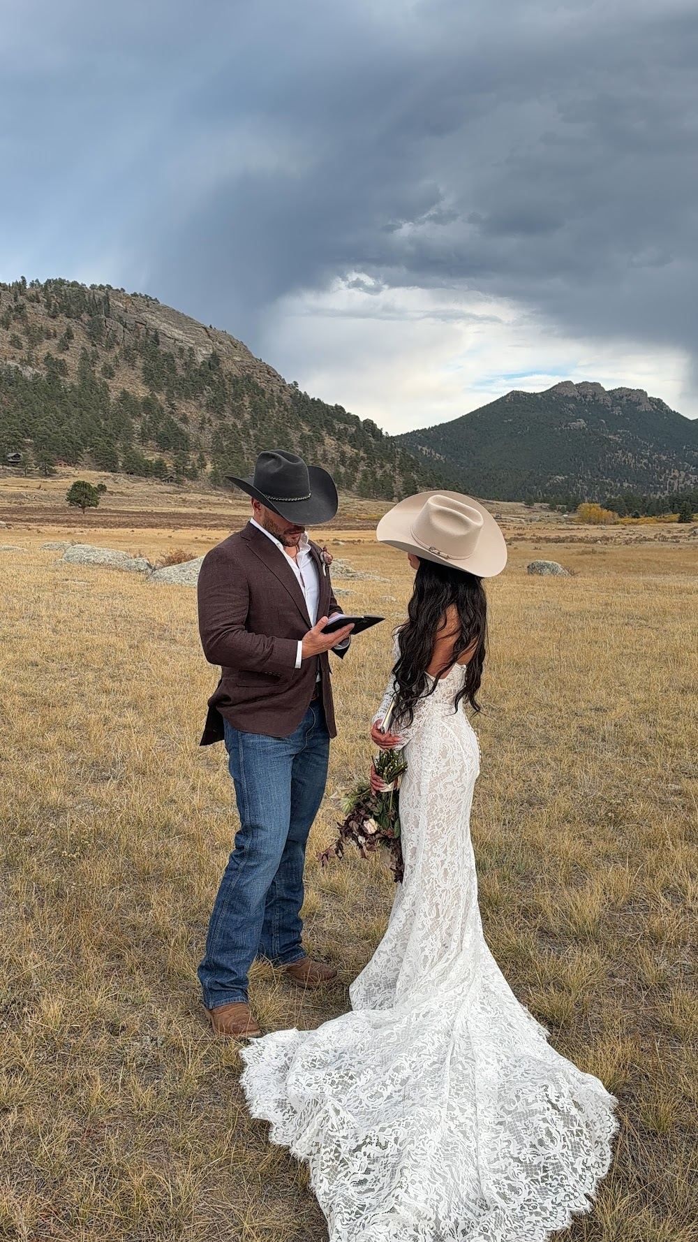 Couple reading vows under a stormy sky